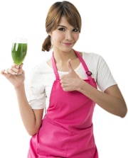 Woman Holding a Glass With Green Liquid