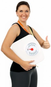 Overweight Woman Holding a Scale With Thumbs up